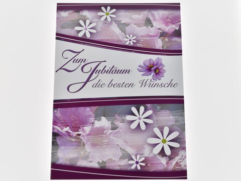 Glückwunschkarte mit verschiedenen Blüten in lila und weißen Farben, dekoriert mit dem Text Zum Jubiläum die besten Wünsche, hergestellt von Juwelier Harnisch.