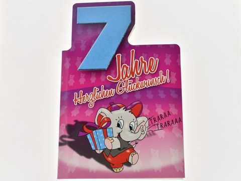 Geburtstagskarte mit einem niedlichen Elefanten, der ein Geschenk hält. Die Karte hat die Aufschrift „7 Jahre Herzlichen Glückwunsch“ und eine farbenfrohe Gestaltung. Hersteller: Juwelier Harnisch.