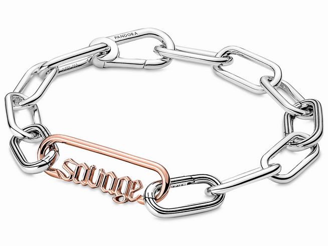 Stylischer Edelstahlarmreif von Pandora mit Roségold vergoldetem Wortlink "savage", kombiniert mit glänzenden und matten Kettengliedern für einen modernen Look.
