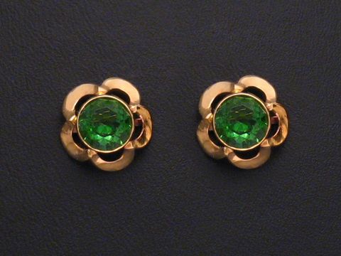 45828-0 Ohrringe in Blumenform mit grün facettierten Steinen, Gold Ohrstecker, Hersteller Juwelier Harnisch, weitere Steine umgeben den zentralen Stein.