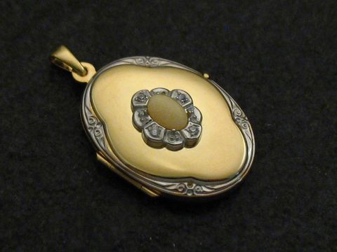 Medaillon aus Gold 333 bicolor mit einer Koralle in weiß als Cabochon, verziert mit filigranen Details, Hersteller Juwelier Harnisch. Ein elegantes Schmuckstück für besondere Anlässe.