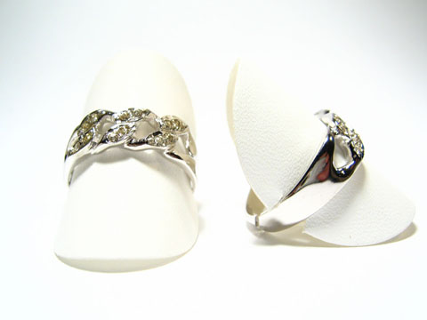 Designer Silber Ring rhodiniert mit weißen Steinen, Hersteller: Juwelier Harnisch, Ringe verstellbar, elegant präsentiert auf ringförmigen Halterungen, glänzende Oberfläche.