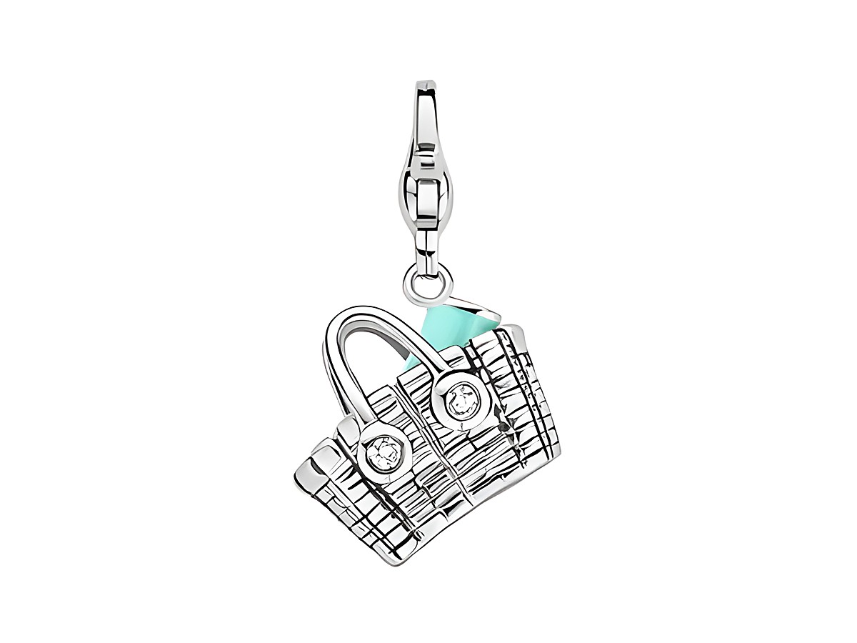 Die Strandtasche Ti Sento aus Silber mit charmantem Design zeigt eine filigrane Korbtasche mit türkisfarbenem Element und funkelnden Details, ideal als Accessoire für den Sommer.