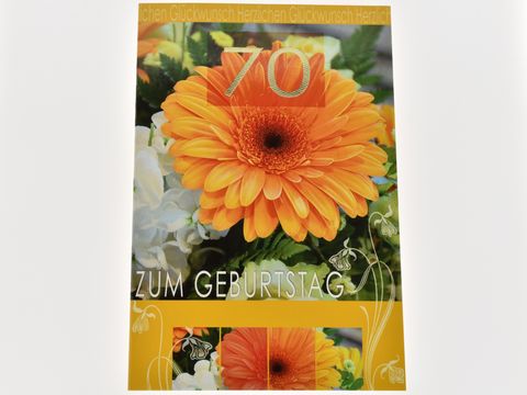 Geburtstagskarte mit einer orangefarbenen Gerbera und dem Aufdruck 70 zum Geburtstag, hergestellt von Juwelier Harnisch, in einem ansprechenden Design mit floralen Elementen.